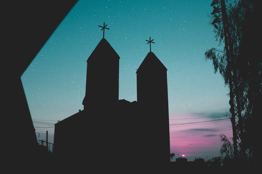 A church silhouette against a starry sky and twilight hues in Lebanon, offering serene and spiritual scenery.